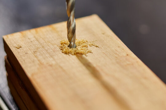 Close Up Of Drilling Into Wood With Screw Twisted Into Place, Metal Drill Bit