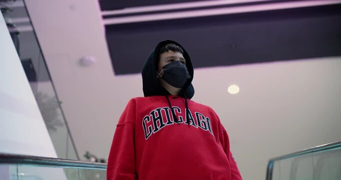 a boy with a protective mask against the virus in the shopping center