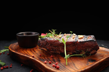 Grilled ribs with sauce on a wooden board