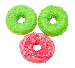 fried donuts with pink and green icing on a white plate