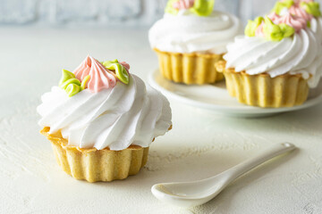 Cake basket with cream on a light table