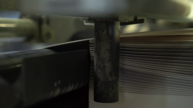 Printed sheets of paper are served in the printing press offset printing