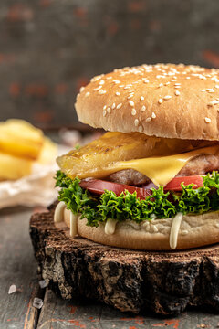 Close-up of home made tasty burger. Street food. fast food and unhealthy eating concept. vertical image. place for text