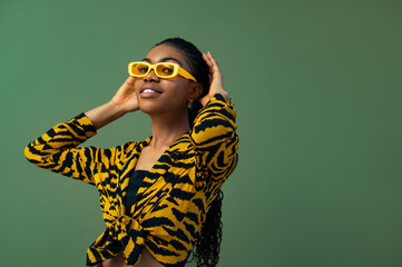Fashionable happy smiling Black woman wearing trendy yellow rectangle sunglasses, animal, tiger...