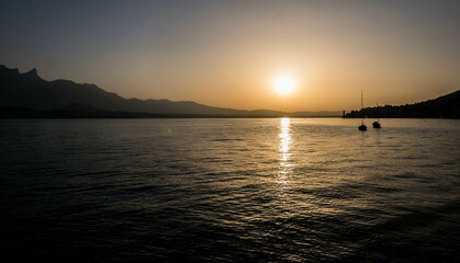 Summer sunset in a lake with two sailing boats