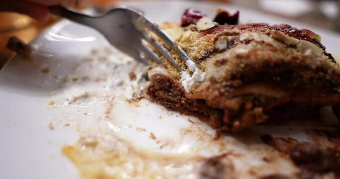 cutting a sweet pancake during a meal with cutlery