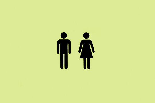 Iconos de ba&ntilde;o masculinos y femeninos sobre un fondo verde liso y aislado. Vista de frente. Copy space