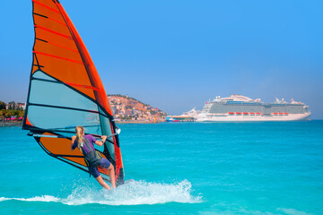 Windsurfer surfing the wind on sea waves - The cruise ship is located on Kusadasi Island in the...