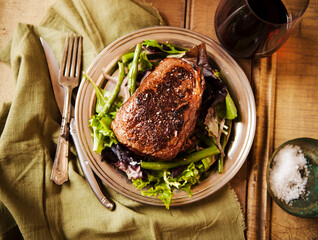 Sliced Grass Fed Sirloin Steak on a Bed of greens