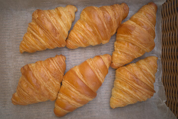 Classic French croissant or butter croisant in wooden basket,which is viennoiserie pastry of Austrian origin