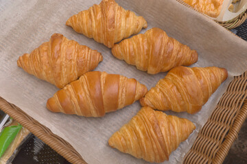 Classic French croissant or butter croisant in wooden basket,which is viennoiserie pastry of Austrian origin