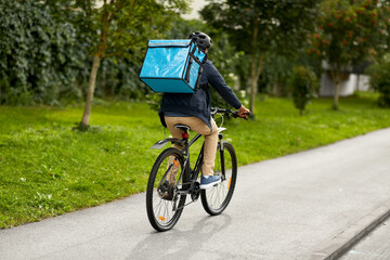 food shipping, transportation and people concept - delivery man in bike helmet with thermal...