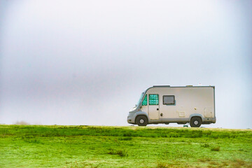 Camper rv camping on nature. Foggy day