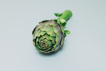 Fresh green Artichokes ion a grey background. Flat lay.