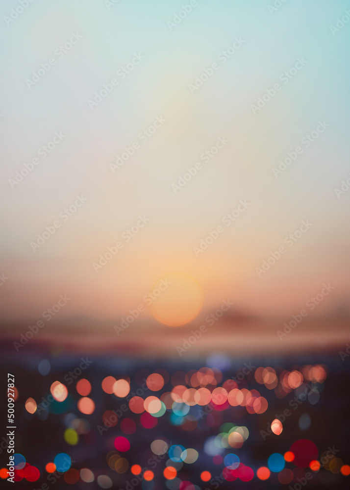 Wall mural evening view of abstract bokeh lights is blurred with the dramatic sky and clouds at dusk.