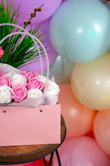 Festive background of a bouquet of roses and colorful balloons
