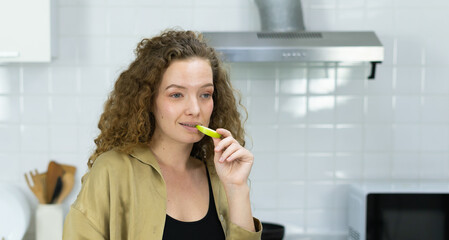 woman smile, eating green apple fruit, looking at space in kitchen with copy space. beautiful caucasian pregnant woman cooking healthy diet fruit or food in kitchen