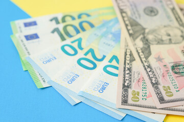 Obraz na płótnie Canvas Euro money and american dollars on a colour paper background