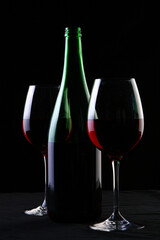 a two wine glasses on black