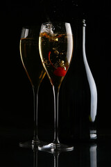 two elegant glasses with gold champagne