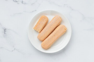 Italian cookie savoiardi. Sweet biscuits. Sponge cookies tiramisu on white background