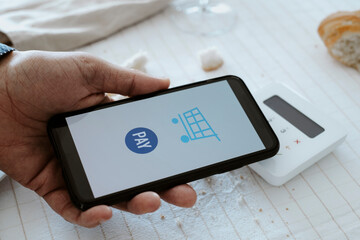 man pays the bill with his smartphone