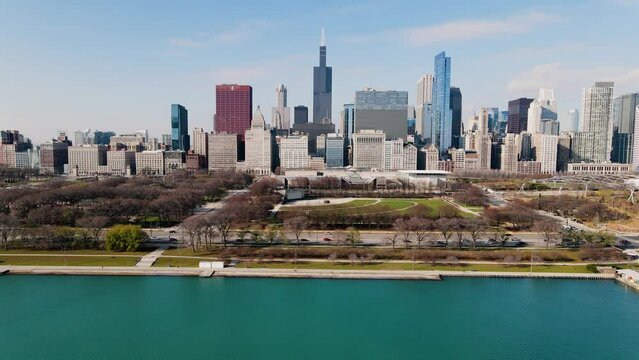 Aerial drone view over the Butler Field, towards the sunny skyline of Chicago, USA