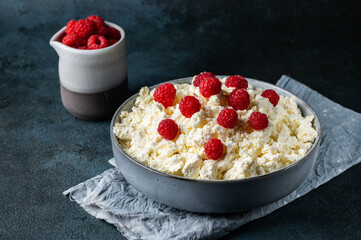 Dieting cottage cheese with fresh raspberry. Healthy breakfast with berries. Dairy products with raspberry. Healthy eating concept