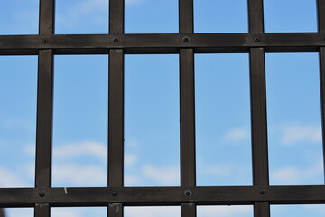 blue sky behind bars ,