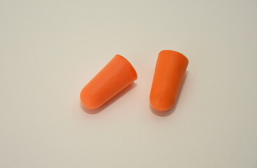 Ear plugs isolated on blue dark background.Orange   ear plugs isolated