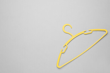 Empty clothes hanger on white background, top view. Space for text