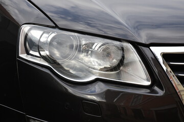 Car's exterior details.Blue car - headlight on a black  car