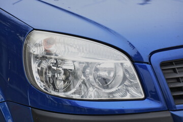 shiny headlight on a blue  car