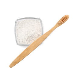 Bowl of tooth powder and brush on white background, top view