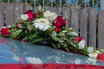 the bride's car decorated with a bouquet of flowers, in Romania