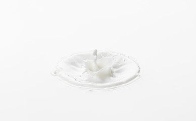 Splash and crown made of milk. Splashes on the surface of milk on a white background.