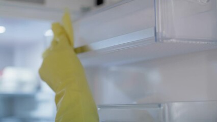 Close up of caucasian woman cleaning fridge at home. Shot with RED helium camera in 8K.  