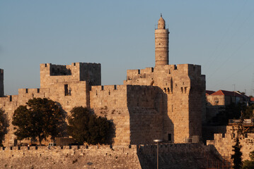 Afternoon view of the landmark, stone Tower of David minaret as golden sunlight strikes the ancient walls of the Old City of Jerusalem. © Yehoshua Halevi