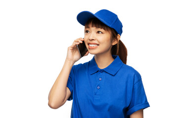 profession, job and people concept - happy smiling delivery woman in blue uniform calling on smartphone over white background
