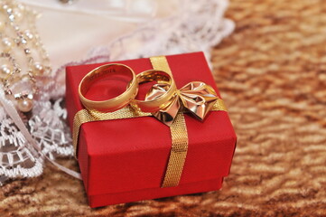 Gold Wedding Ring on the white pillow 