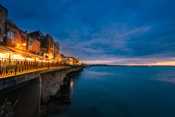 Long exposure of Ortigia at sunset on the sea