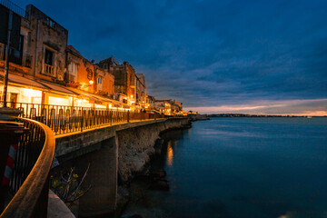 Long exposure of Ortigia at sunset on the sea