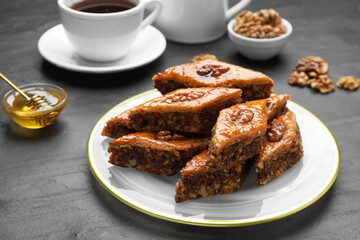 Delicious sweet baklava with walnuts on black table