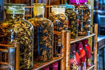 Close-up of aged tangerine peel in glass jars in a medicinal store