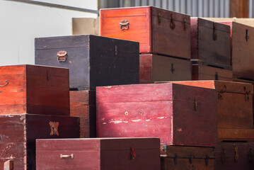 Pile of old vintage big wooden boxes stacked in a furniture store