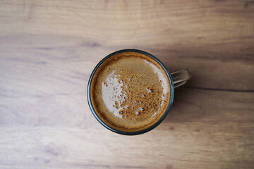 close up of a coffee cup on wooden table
