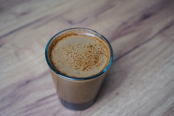 close up of a coffee cup on wooden table
