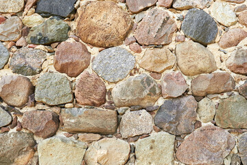Fragment of an old stone wall. Ancient rock background