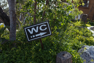 Direction to the toilet on the beach.WC - the inscription on the sign