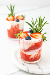 Delicious healthy breakfast, strawberry smoothie with natural yogurt and blueberries and rosemary